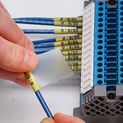 A terminal block with many neatly labeled wires.