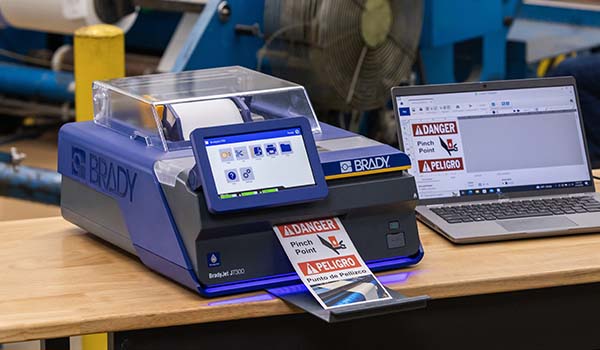 J7300 printer on a desk in a manufacturing facility.