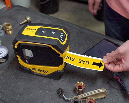 A yellow pipe marker printing on the M511 printer.