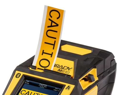 A Brady M610 printer quickly printing a caution label