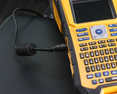 A Brady M610 printer recharging in a car.