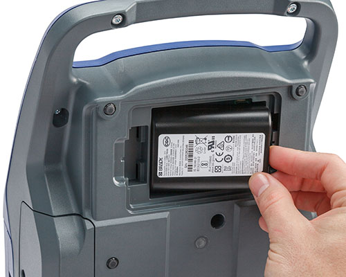 A battery being inserted in the bottom of the M710 printer.