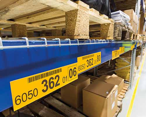 A row of neatly labeled bins in a warehouse.