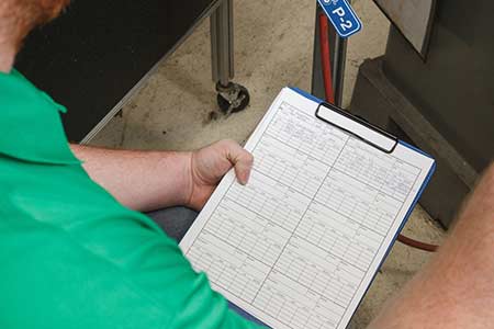 A person working through a safety checklist.