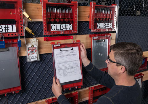 Image of a man hanging up paperwork