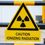 A yellow ionizing radiation symbol indicates dangerously high levels of radiation in the lab.