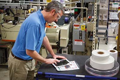 A warehouse manager updating lockout tagout procedures, incorporating insights gained from regular inspections to enhance safety measures.