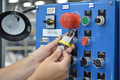 A contractor improperly removing a lockout tagout padlock without the required authorization, highlighting a breach of safety protocol.