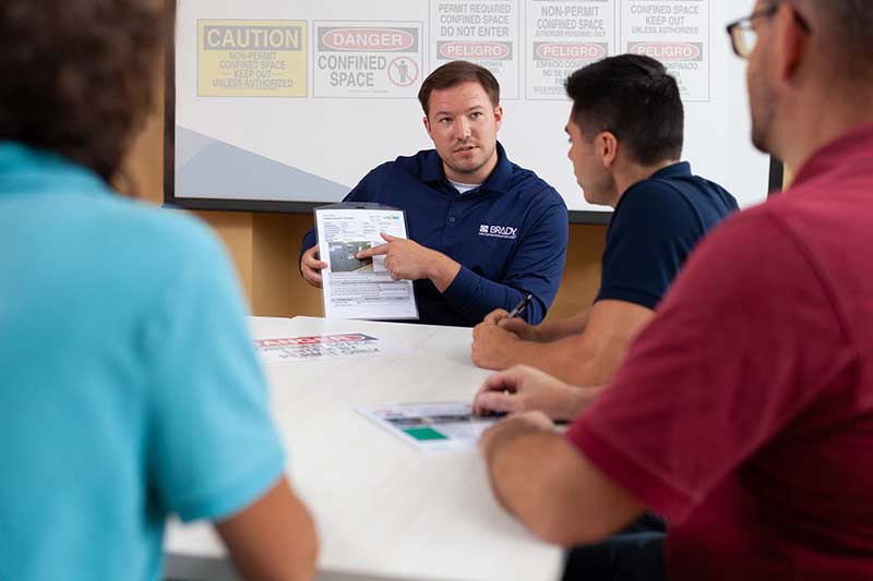 A manager walks through safety protocols with his employees.